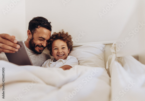 Картината върху платно Father and son having fun at home