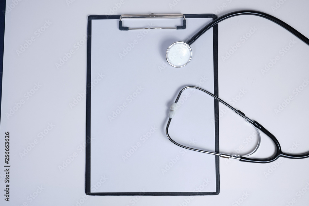 phonendoscope with a folder with white sheets of paper with on a white background phonendoscope with a folder with white sheets of paper with on a white background