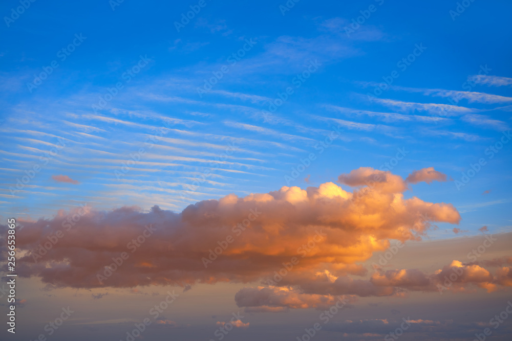 Sunset clouds in orange and blue sky