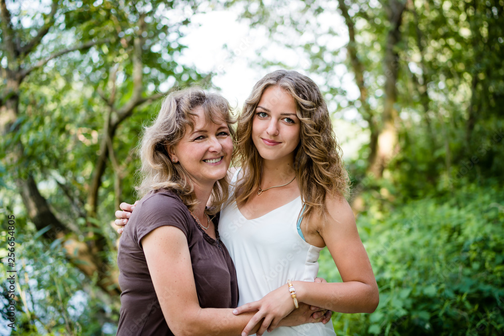 Mother and daughter hugging each other with love