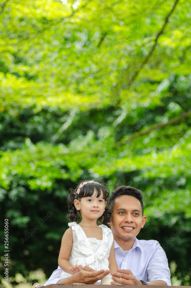 young father spending time with his daughter at park during weekend young father spending time with his daughter at park during weekend