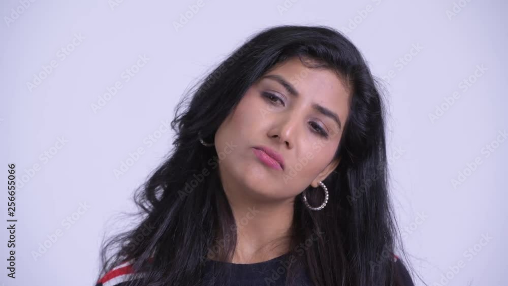Face of young stressed Persian woman looking bored and tired Face of young stressed Persian woman looking bored and tired