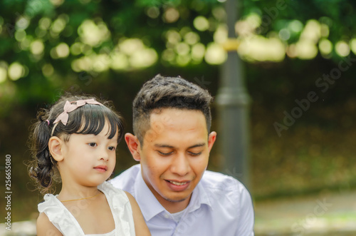young father spending time with his daughter at park during weekend