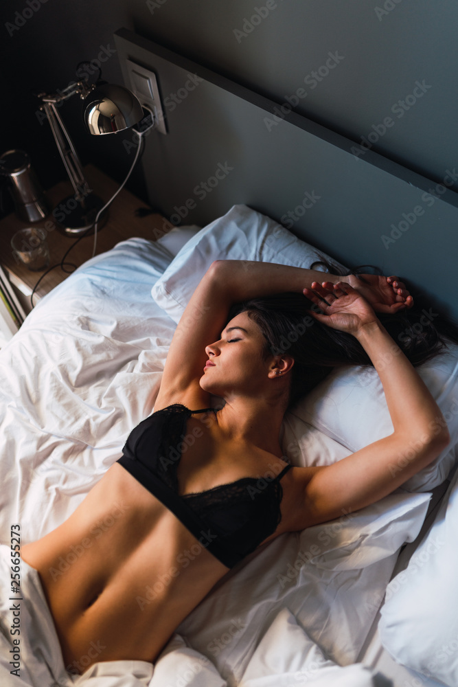 Young sensual slim woman in lingerie sleeping on bed Stock Photo | Adobe  Stock