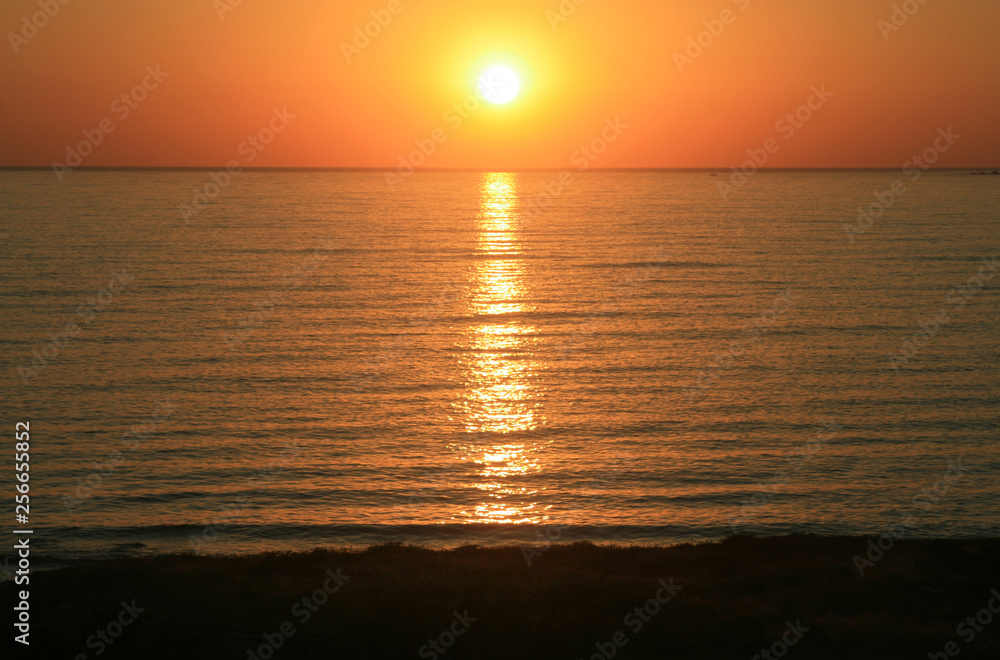 Fototapeta premium Orange sunset over the sea