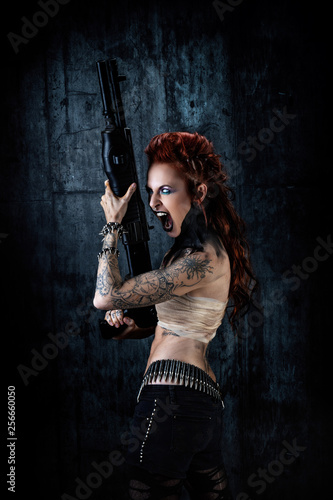 Young tattooed woman  one-eyed  rifle in his hands