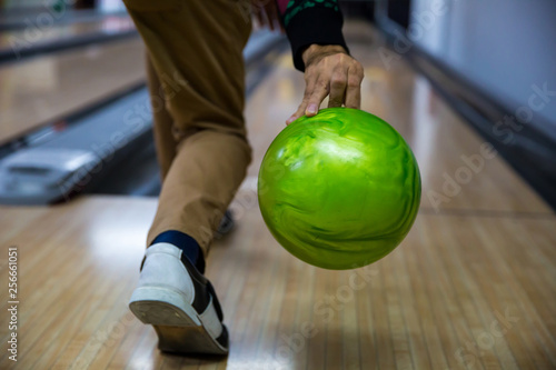 Man's hand holding a bowling ball ready to throw it