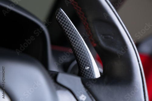 Carbon fibre paddle shifting on black leather steering wheel