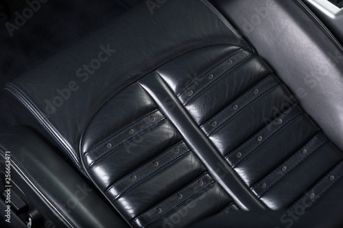 Close up of black leather car seat
