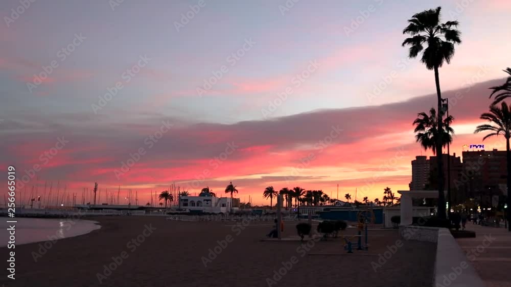 Sunset over the beach and harbor of Fuengirola, Malaga, Spain Sunset over the beach and harbor of Fuengirola, Malaga, Spain