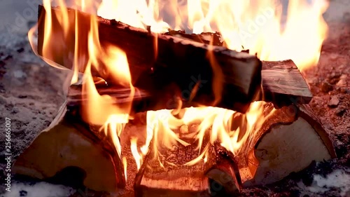 firelogs burning in Lemmenlaakso fireplace in winter in Finland. shot in fhd in 60fps photo