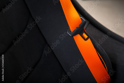 Orange belt on sports car seat
