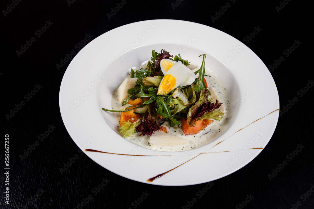Salad with egg, red pepper, cheese and tomato served on a plate. Salad with egg, red pepper, cheese and tomato served on a plate.