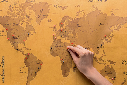 Woman pinning on world map