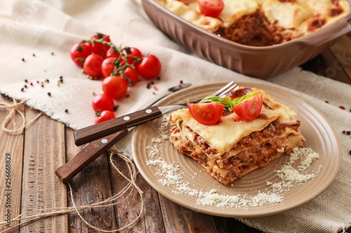 Tasty baked lasagna on wooden table