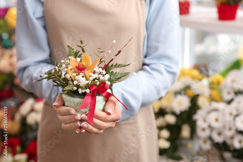 Female owner with beautiful flowers in shop