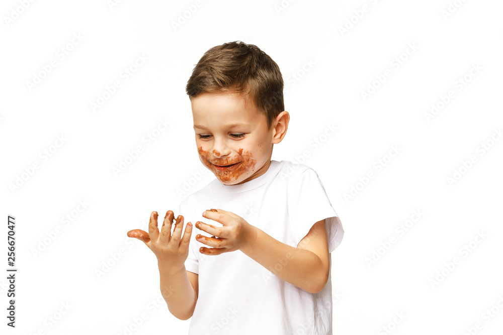 little boy with face and hands in chocolate little boy with face and hands in chocolate