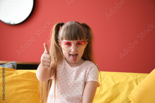 Funny little girl showing t...