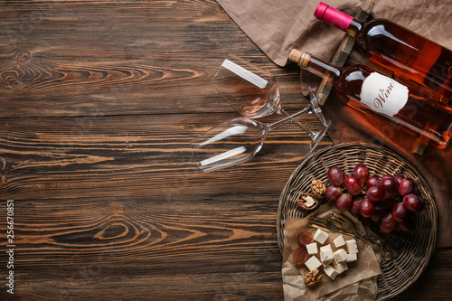 Composition with wine and snack on wooden background