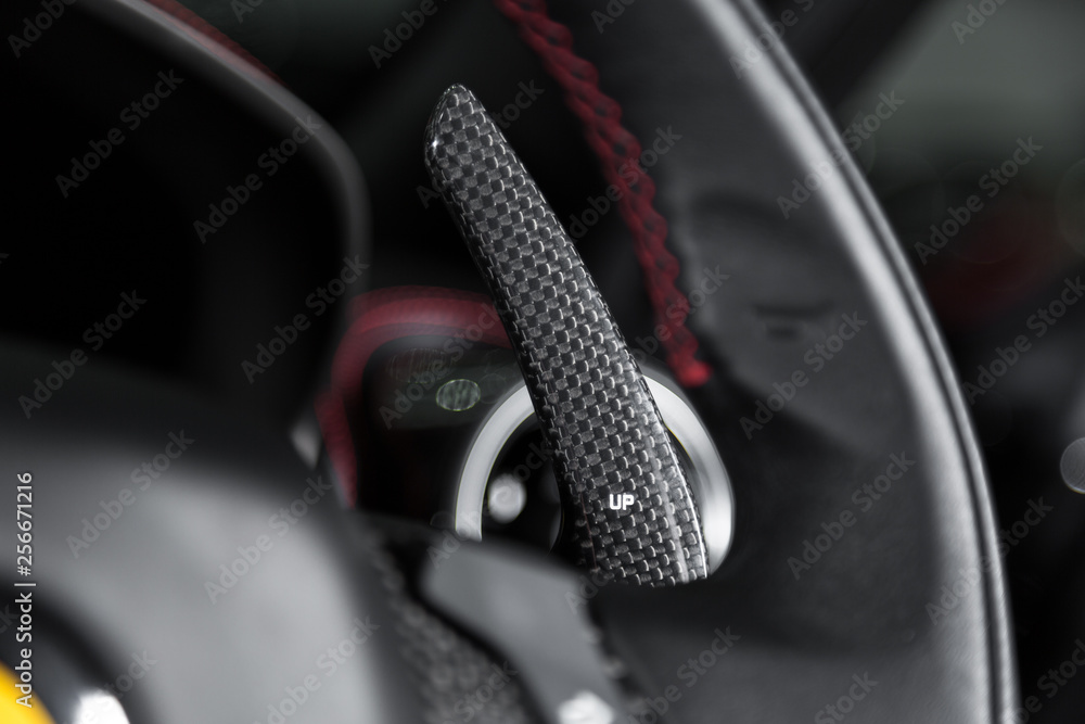 Carbon fibre paddle shifting in sports car steering wheel