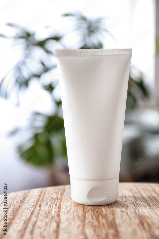 Tube with natural cream on wooden table Tube with natural cream on wooden table