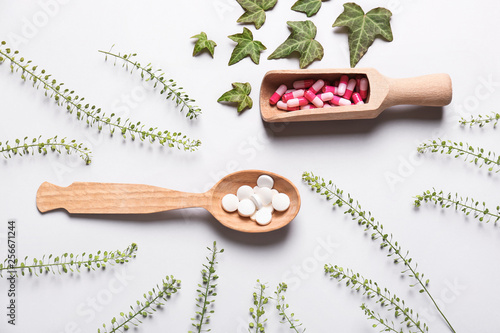 Photos Different plant based pills on light background