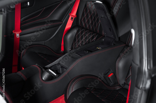 Black passenger seats in luxury sports car interior © camerarules