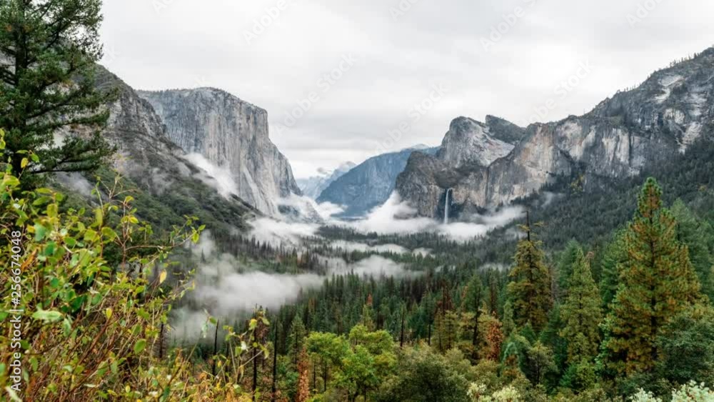 Time-lapse of Fall in Yosemite Valley in California. Misty clouds along with a distant waterfall are visible and moving Time-lapse of Fall in Yosemite Valley in California. Misty clouds along with a distant waterfall are visible and moving