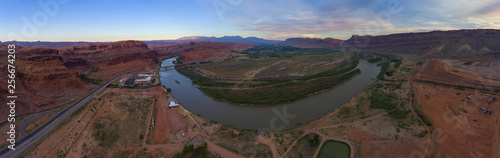 Aerial view of Colorado River and La Sal Mountains panorama at sunset near Arches National Park in Moab, Utah, USA.