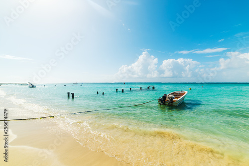 Small wooden boat moored in beautiful Sainte Anne beach in Guadeloupe