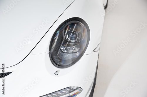 Headlight of white sportscar
