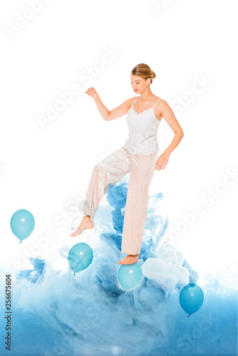 girl in pyjamas standing on blue ballons with cloud illustration