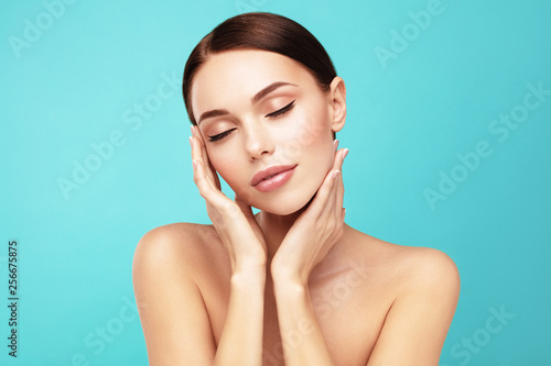 Felling clean and fresh. Skin care,Beauty treatment and spa concept. Attractive model with brown hair and perfect Skin touch own face with closed eye