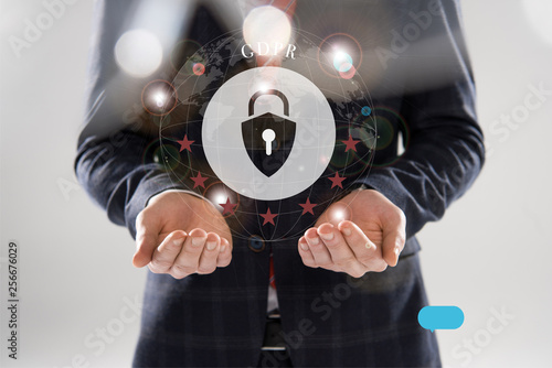 cropped view of businessman in suit with outstretched hands and gdpr letters and lock illustration in front