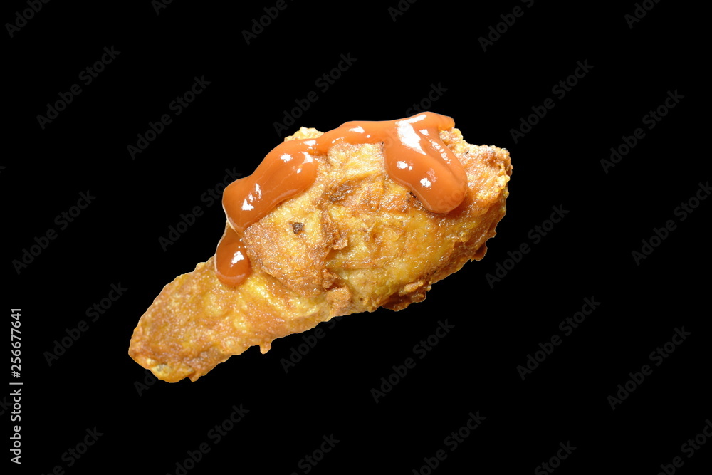 crispy fried chicken leg dressing ketchup sauce on black background crispy fried chicken leg dressing ketchup sauce on black background