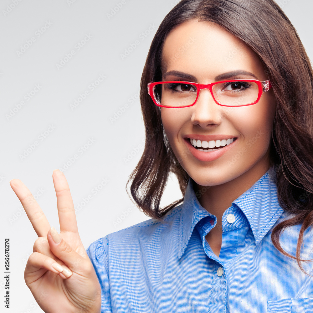 Businesswoman showing two fingers or victory gesture Businesswoman showing two fingers or victory gesture