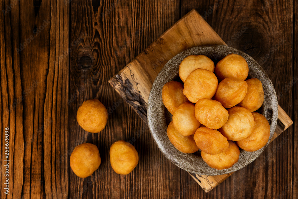 Baursak - traditional Kazakh (Asia) food \ national bread in plate on wooden background, top view