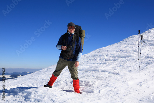Tourist in the winter mountains