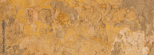 Beige yellow color, painted and faded wall texture grunge background