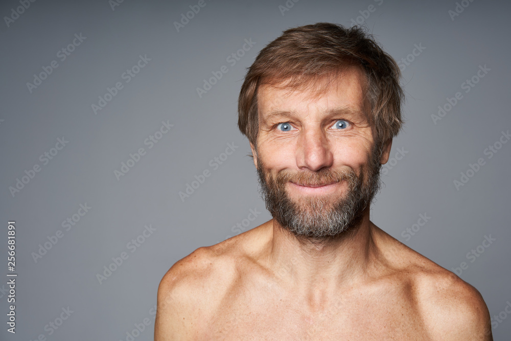 Obraz premium mature man shirtless standing smiling at camera