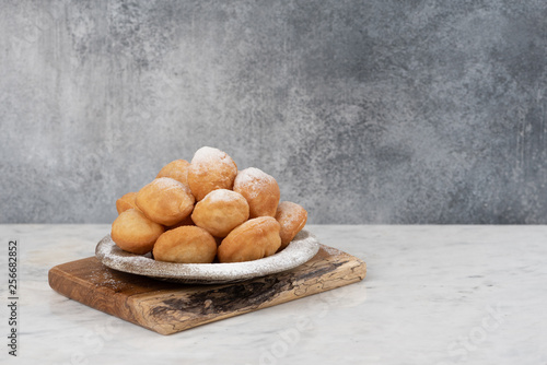 Baursak - traditional Kazakh (Asia) food \ national bread in plate on marble  background photo