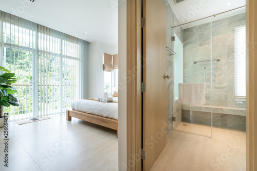  Luxury Interior design in modern bedroom with hallway bathroom of pool villa with cozy king bed high raised ceiling in the  home, house , building , hotel , resort