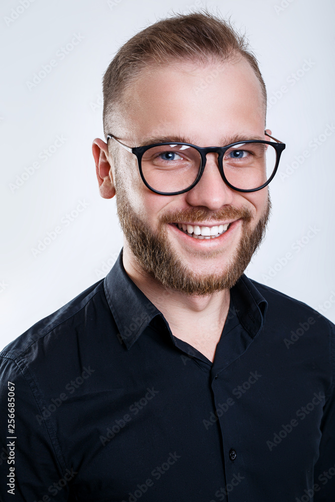 Laughing man in spectacles, close up studio portrait