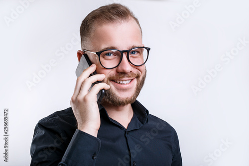 Close up portrait of cheerful man making a phone call