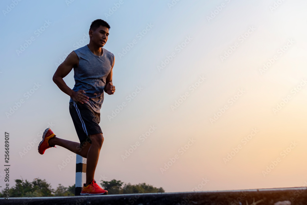 young man runner running on road. healthy lifestyle young fitness man running. young man runner running on road. healthy lifestyle young fitness man running.