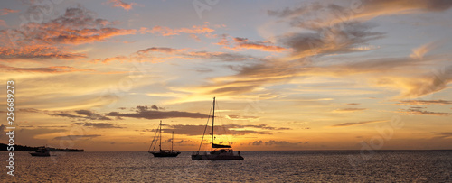 Morris M46 Yacht during sunset with orange sky in the Caribbean Sea near Union Island. photo