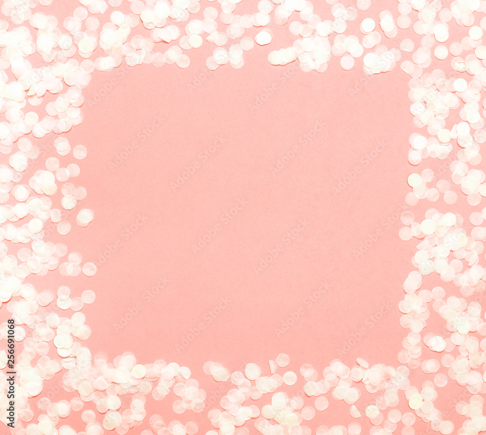 Frame of paper round confetti with clear square in the middle on pastel coral background top view Flat lay. Festive holiday background party birthday christmas new year. Color 2019 Living Coral