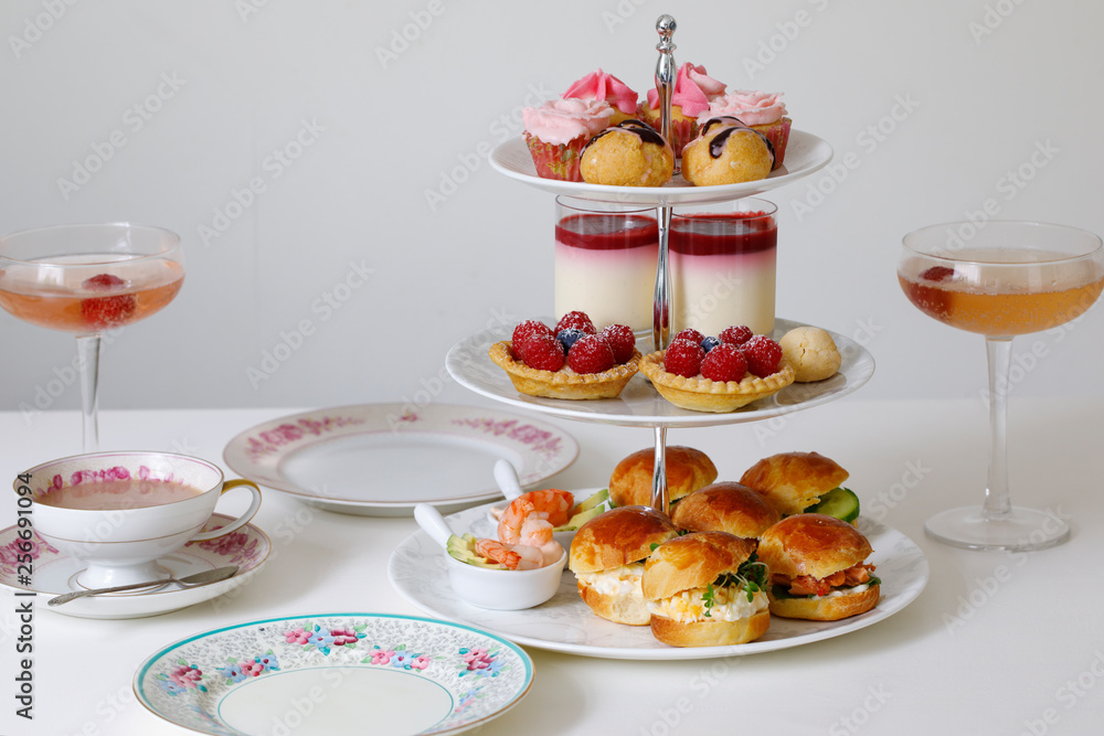 Afternoon tea with mini brioche canapes and selection of sweets Afternoon tea with mini brioche canapes and selection of sweets