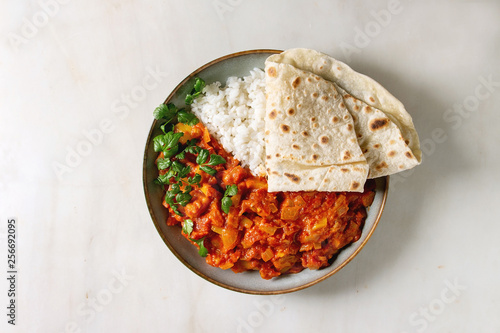 Wallpaper Mural Vegan vegetarian curry with ripe yellow jackfruit served in ceramic bowl with rice, coriander and homemade flatbread flapjack over white marble background. Flat lay, space Torontodigital.ca