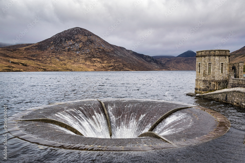 This is a picture of an overflow drain in reservoir. The water is
